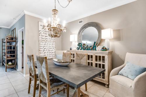 a dining room with a table and chairs and a chandelier at South Harbour 04C in Pensacola Beach
