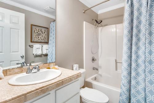 a bathroom with a sink and a toilet and a shower at South Harbour 04C in Pensacola Beach