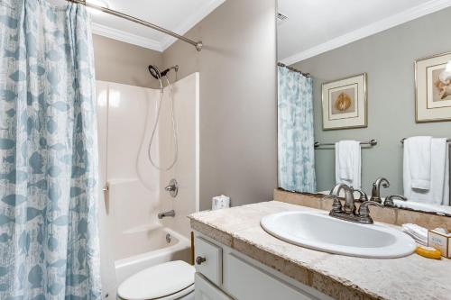 a bathroom with a sink and a toilet and a shower at South Harbour 04C in Pensacola Beach