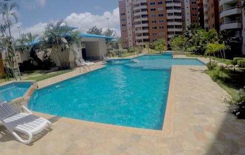 a large swimming pool with a chair and avisorvisor at Lo mejor de isla Margarita in Pampatar