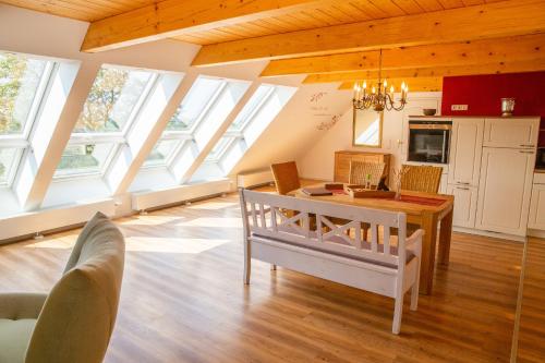 a living room with skylight ceilings and a table and chairs at Haus im Felde Whg 5 in Fehmarn