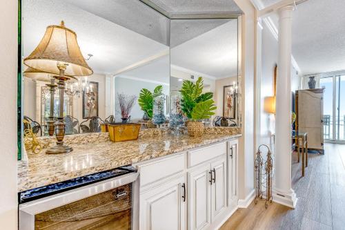 a kitchen with a counter with a large mirror at Pearl 1305 in Navarre