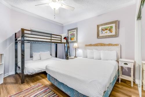a bedroom with two beds and a ceiling fan at Pearl 1305 in Navarre