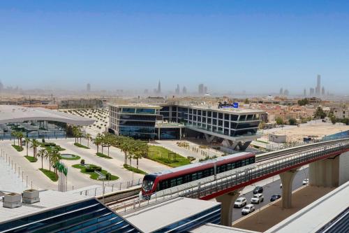 a train on a bridge over a city at Radisson Blu Hotel Riyadh Convention and Exhibition Center in Riyadh