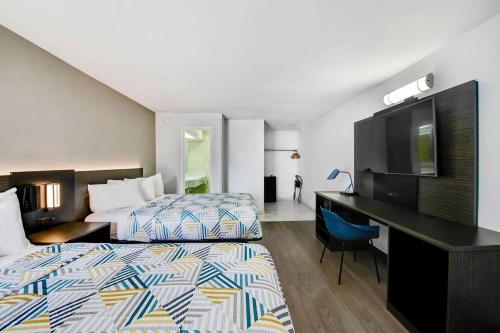 a hotel room with two beds and a desk at Motel 6 Atlanta, Ga - Midtown in Atlanta