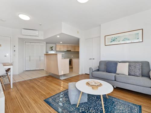 a living room with a couch and a table at RESORT ON THE BEACH 2214/2215 in Kingscliff