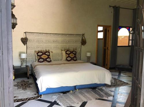 a bedroom with a large bed in a room at villa Oulad Hassoune in Mellah Bakka