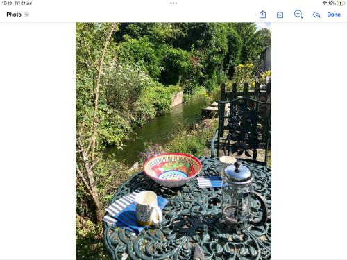 a picnic table with a view of a river at THE MORNINGSIDE APARTMENT Charming stylish apartment in the centre of Innerleithen in Innerleithen