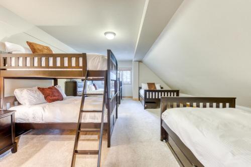 a attic bedroom with two bunk beds and a staircase at #301 Grand Lodge South Master Suite in Government Camp