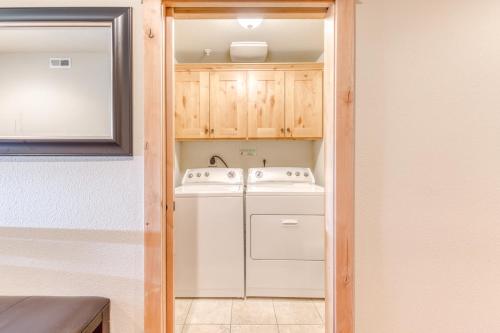 a small kitchen with a washer and dryer at #202 Grand Lodge South in Government Camp