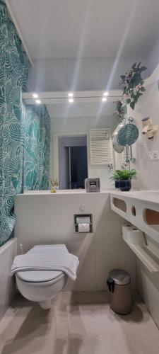 a bathroom with a toilet and a sink at Bianca Apartment in Bissone