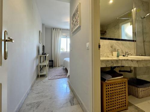 a bathroom with a sink and a mirror at Blue House in Guadalmina Baja, with a large terrace overlooking the Golf in Marbella