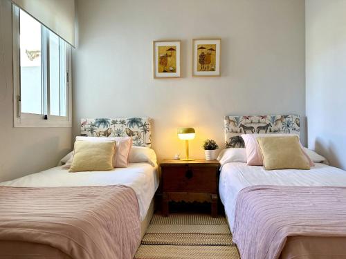 two beds sitting next to each other in a room at Blue House in Guadalmina Baja, with a large terrace overlooking the Golf in Marbella