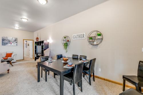 a dining room and living room with a table and chairs at Port Susan Bay in Sunny Shore Acres