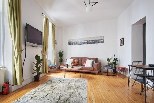 a living room with a couch and a tv at Your home heart of Istanbul in Istanbul