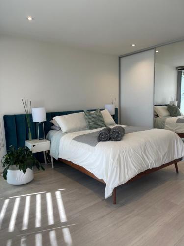 a bedroom with a large bed with a large mirror at Lakeview Luxe - EV charger, Pool, Gym, Location + in Kingston 
