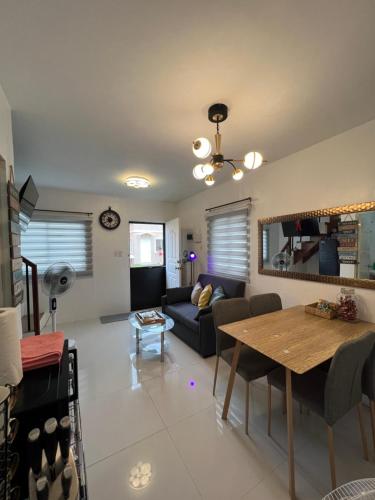 a living room with a table and a couch at Nyssa Crib 2BR Whole Townhouse Camella Bacolod South in Bacolod
