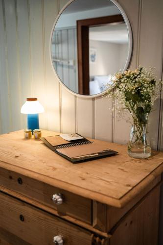 a table with a laptop and a mirror on it at Ferienwerk in Ofterschwang