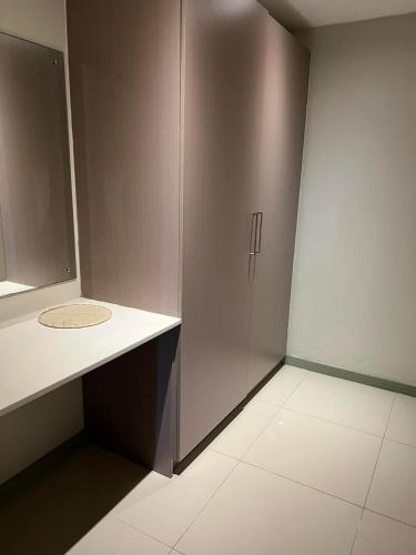 a bathroom with a cabinet and a tile floor at Pacific FairPrice in Nadi