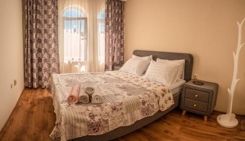 a bedroom with a bed with two towels on it at Melia lux apartment in Ravda