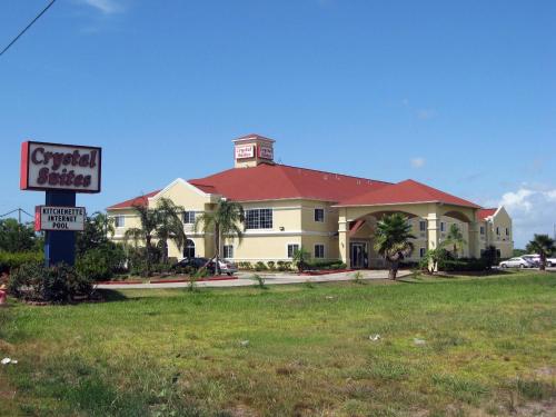 a large building with a sign in front of it at Crystal Suites in Texas City