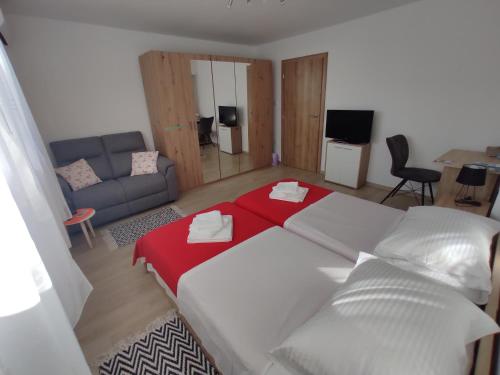 a bedroom with a large bed and a couch at Apartment Deeranaei in Kraljevica