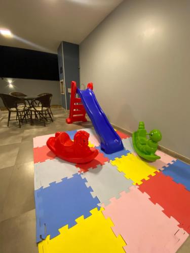 a play room with a table with toys on it at Recanto da Natureza & SPA in Penha