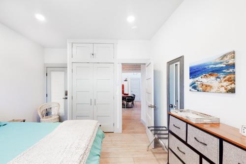a bedroom with a bed and a desk at Driftwood Duet in Bandon