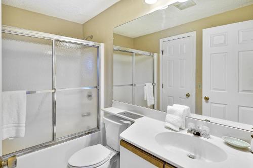 a bathroom with a toilet and a sink and a shower at Winterplace Getaway A101 in Ludlow