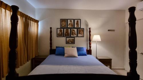 a bedroom with a bed with blue sheets at Your Little Paradise - Juan Dolio in Juan Dolio