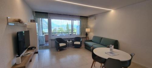 a living room with a couch and a table at Relax-Lugano Lake in Bissone