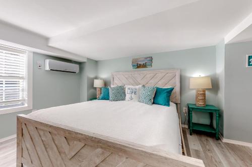 a bedroom with a large bed with blue pillows at Lazy Seagull Beach House in South Padre Island
