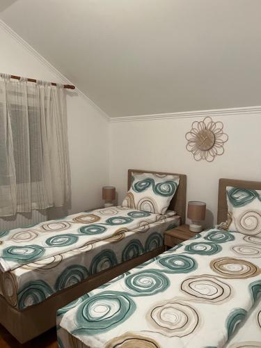 a bedroom with two beds and a window at Guest Radic Room in Palić