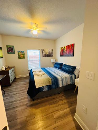 a bedroom with a bed with blue pillows on it at Beach Room, for wonderful Vacation in Panama City Beach