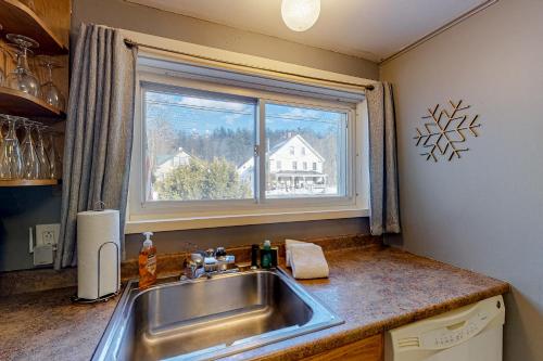 a kitchen with a sink and a window at Vermont Farm House and Studio in Proctorsville