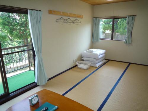 a living room with a chair and a table at Tabi No Yado Harusame in Kumano