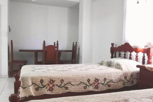 a bedroom with a bed with a quilt on it at Monoambiente Amplio y Cómodo Excelente Ubicación en Av Roca in Santiago del Estero