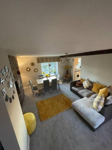 a living room with a couch and a table at Yew Tree Cottage, 3 bedroom, 4 Church Row Defynnog in Devynock