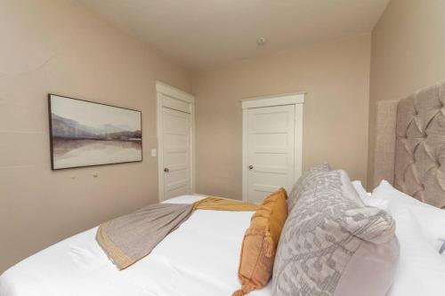 a bedroom with a bed and a painting on the wall at Renovated 2 bed 2 bath Near Arena and Downtown in Spokane