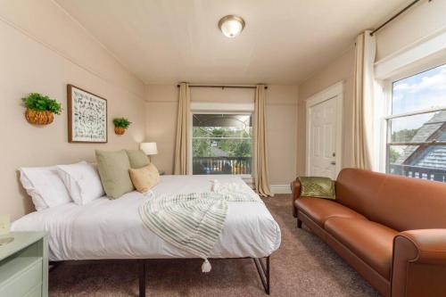 a bedroom with a bed and a couch and a window at Historic 2 KING BED 1 Bath Near Downtown Spokane in Spokane