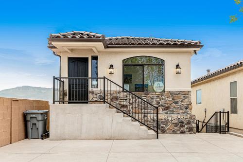 a home with a stone staircase and a window at Red Desert Villa in Hurricane