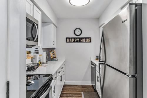 a kitchen with a refrigerator and a happy mother sign on the wall at 1062 Riverfront in Nashville