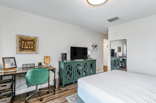 a bedroom with a bed and a desk and a television at 1062 Riverfront in Nashville