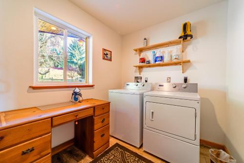 a kitchen with a washer and dryer and a window at Camelot Sanctuary in Fortuna