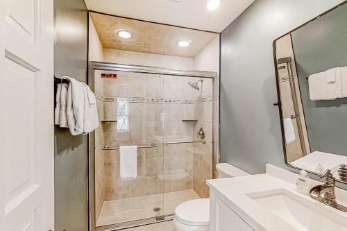 a bathroom with a shower and a toilet and a sink at Smoky Mountain Estate in Sevierville