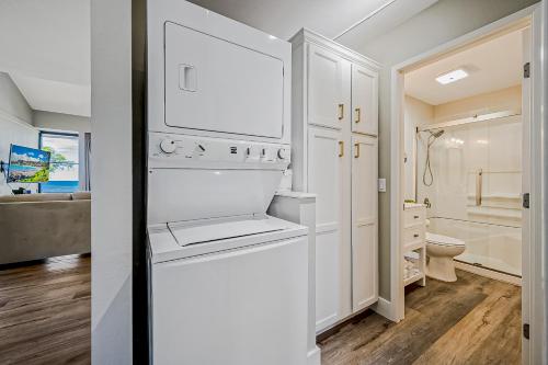 a white bathroom with a toilet and a sink at Kihei Holiday 311 in Kihei