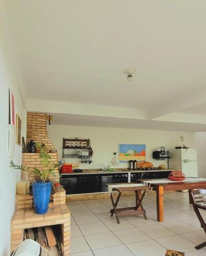 a kitchen with a table and a counter top at Pousada Paraty Graziela in Paraty