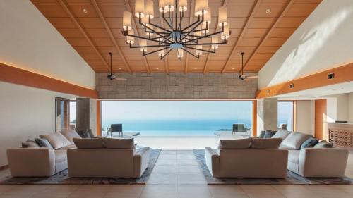 a large living room with a large chandelier at Izu Hotel Resort & Spa in Higashiizu