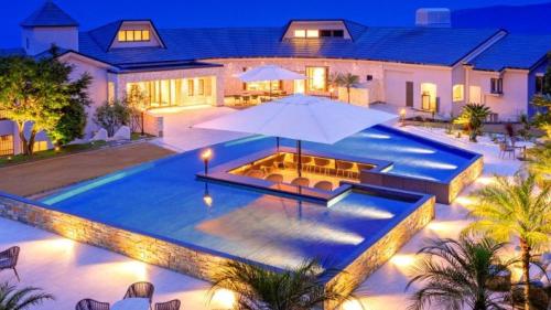 a house with a swimming pool at night at Izu Hotel Resort & Spa in Higashiizu