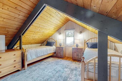 two beds in a attic bedroom with wooden ceilings at Summit View in Bondville